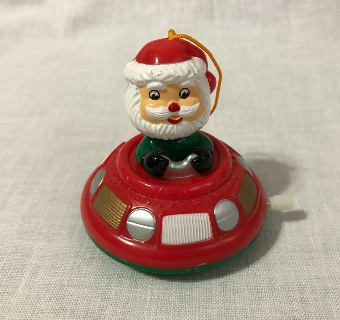 Santa Claus In Wind Up Flying Saucer Spins And Rolls Christmas Toy Ornament